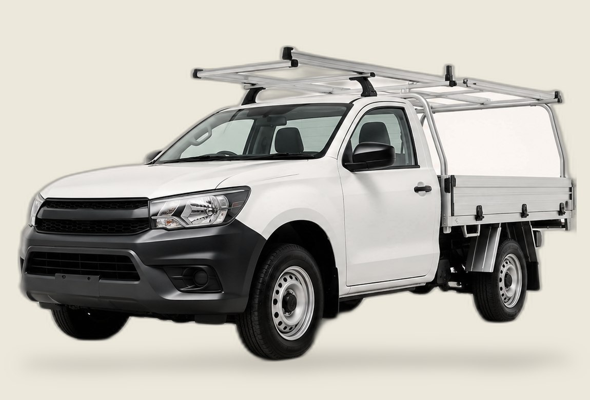 White tradie ute with ladder racks and alloy tray