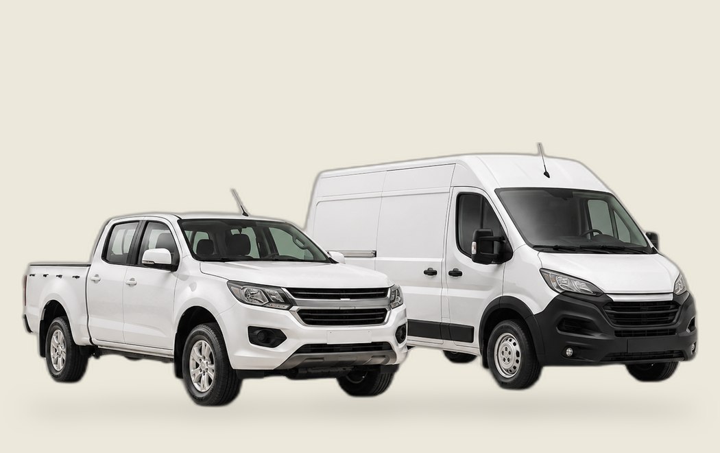 White dual-cab ute and white delivery van side by side
